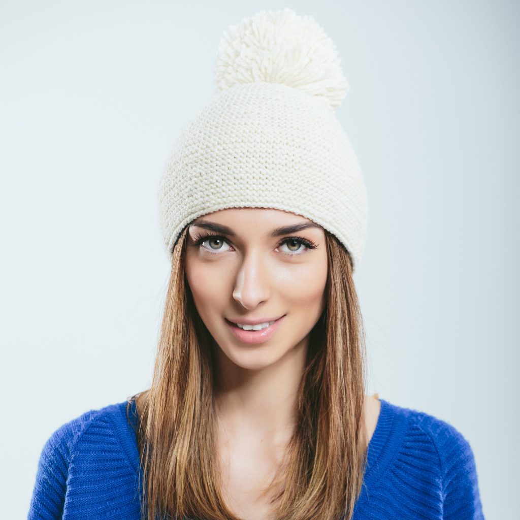 Fashionable girl in winter knitted clothes. Studio portrait